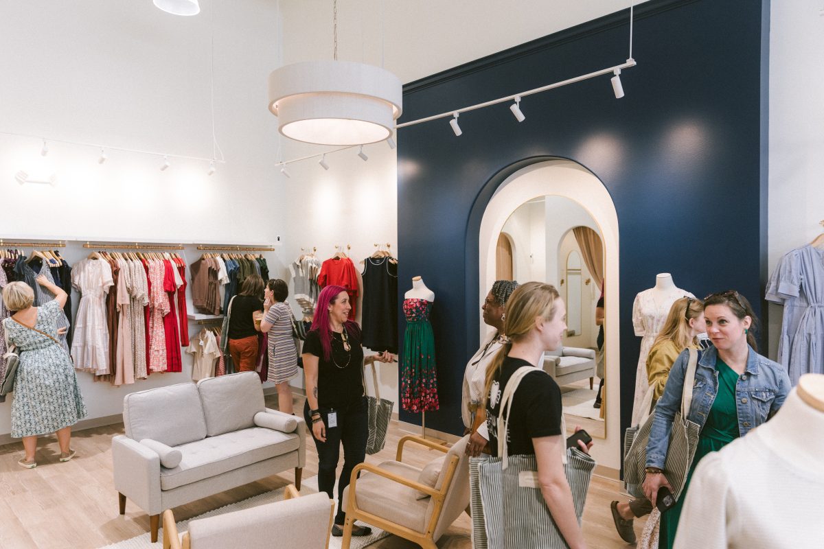 Customers browsing women’s apparel at Evolverie Clothing boutique.